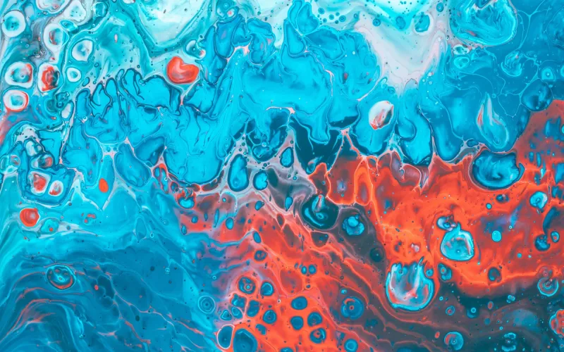 Remolino abstracto de tinta turquesa y roja a modo de imagen conceptual