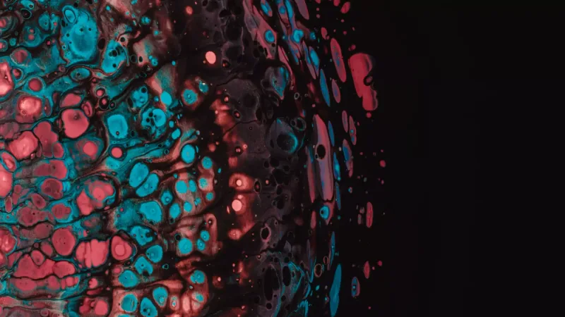 Textura abstracta con burbujas turquesa y un resplandor rosa fundiéndose en negro