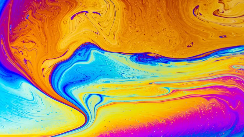 Textura fluida de pintura en tonos naranja, amarillo y azul intenso