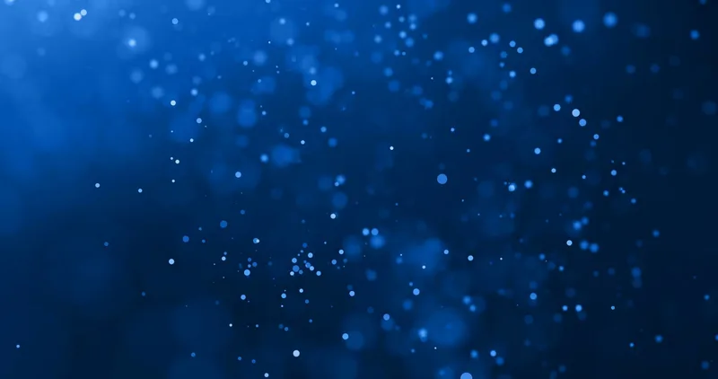 Fondo abstracto azul con partículas de luz difuminadas tipo bokeh