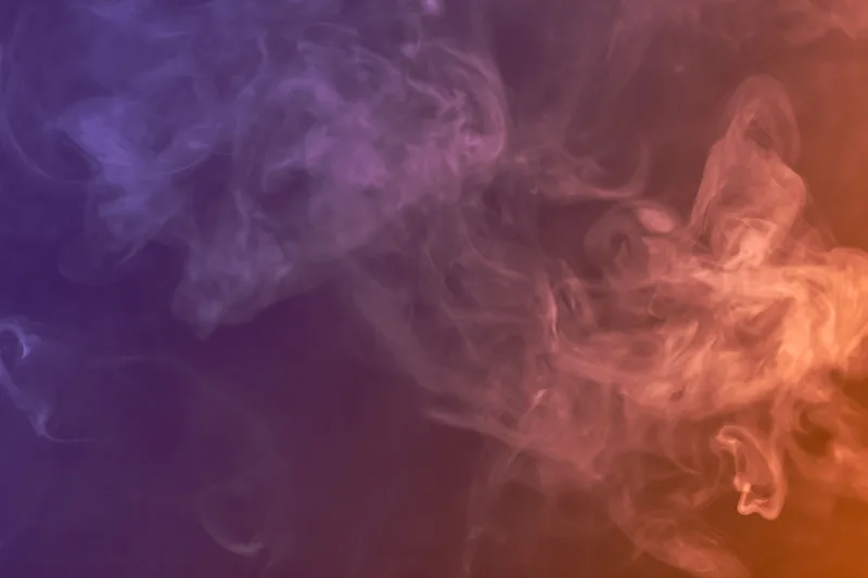 Imagen abstracta de humo en tonos morados y naranjas usada como portada del artículo
